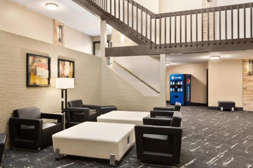 a waiting room with tables and chairs and a pepsi machine at Carrollton Hotel in Carroll