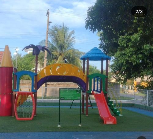 a playground with a colorful slide and a slideintend at Cakau House - espaço amplo e aconchegante in Maricá