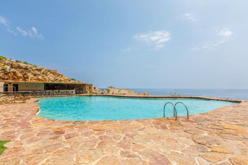 a large swimming pool with the ocean in the background at Cap Sa Sal Aquamarina Begur in Begur