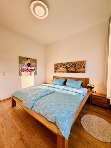 a bedroom with a bed with a blue comforter at Attraktive Wohnung im schönen Hinterhof in Schwerin