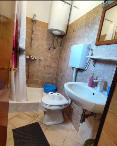 a bathroom with a toilet and a sink at Manora Sucuraj one bedroom apartment in Sućuraj