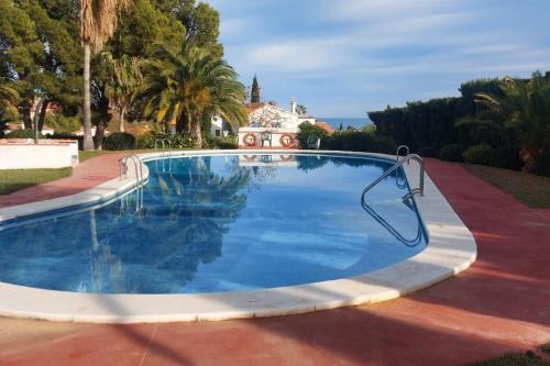 een groot zwembad met een metalen hek eromheen bij Acogedor apartamento con vistas 80 m2 in Alcossebre