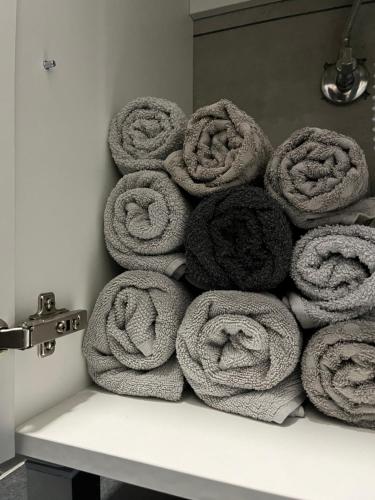 a pile of rolled towels sitting on a shelf at Stan na dan Apartman TRG in Derventa