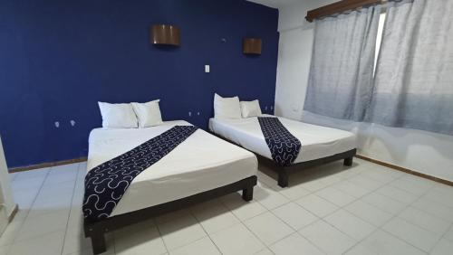Postel nebo postele na pokoji v ubytování Hotel Tropical