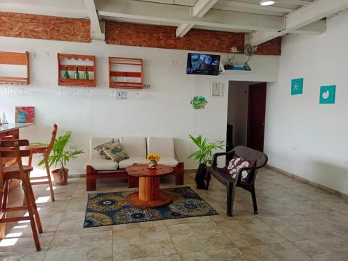 a living room with a couch and a table and chairs at Apartamentos Cielo y Mar in San Andrés