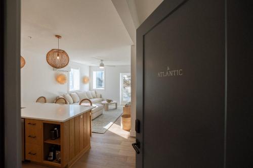 an open door to a kitchen with a living room at The Atlantic at The Tarrymore in Wrightsville Beach