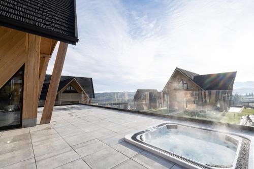 a hot tub on the roof of a house at Chaletovo Mountain Residences in Zakopane