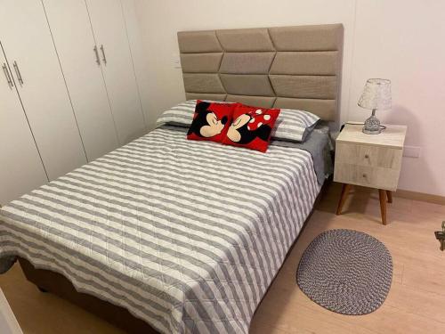 a bedroom with a bed with two mickeys pillows on it at Apartamento en Barranco in Lima