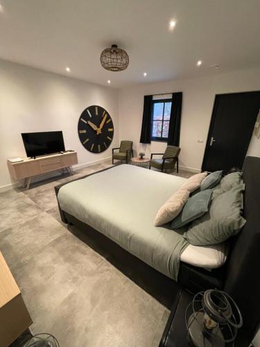 a bedroom with a large bed and a large clock at B en B Stipdonk in Lierop