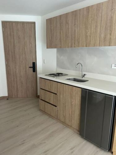 an empty kitchen with a sink and a door at Apartamento en Usaquen in Bogotá