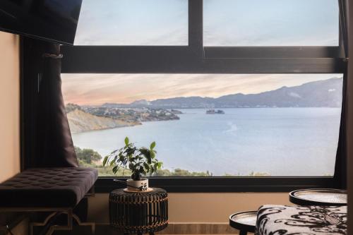 a large window with a view of the water at Athenea Villas, Private Pools & Gardens in Keri