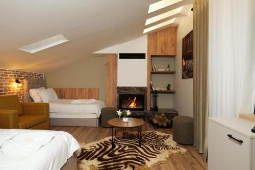 a hotel room with a bed and a fireplace at Vila Muslli in Korçë