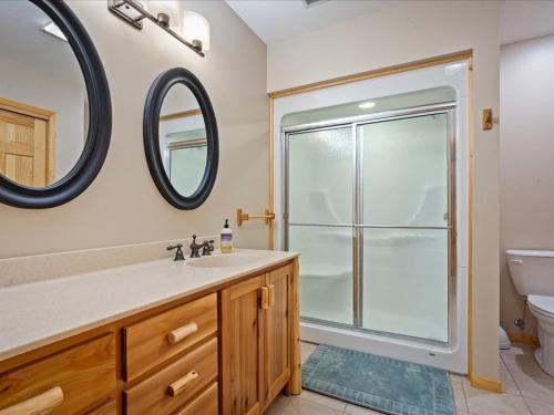 a bathroom with a shower and a sink and a mirror at Longbow Lodge in Walker