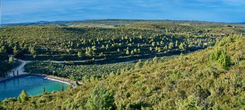 an aerial view of a mountain with a river at Finca Heredad La Boquilla in Enguera