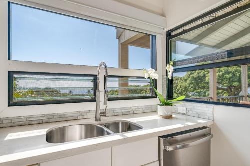 a kitchen with a sink and two windows at Wailea Ekolu 102 - Molokini Views, Split AC in Wailea