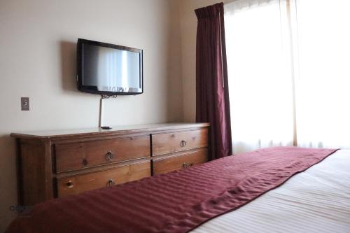 Postel nebo postele na pokoji v ubytování Ohkay Hotel Casino