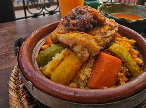 a bowl of food sitting on a table at Hôtel Restaurant BOUGAFER in Oulad Akkou