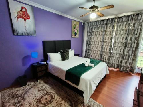 a bedroom with a bed and a ceiling fan at Sabie House -3 bedrooms, OR Tambo, Kempton Park, Johannesburg in Kempton Park