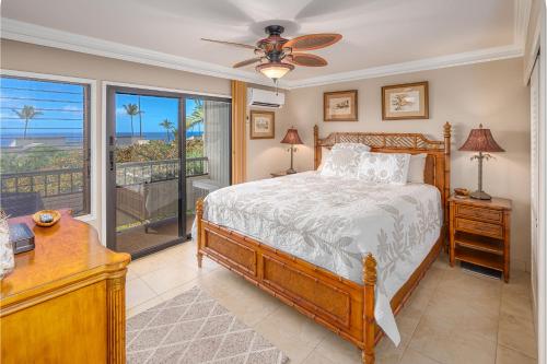 a bedroom with a bed and a view of the ocean at Wailea Ekolu 407 - Renovated, Split AC, Ocean View in Wailea