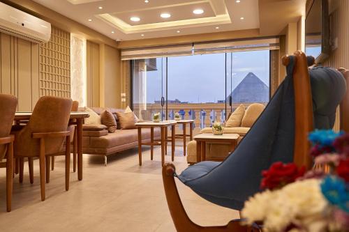 a living room with a hammock and a view of a pyramid at Pyramids Charm Hotel in Cairo