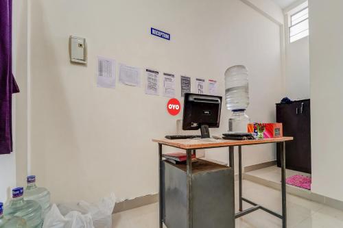 a desk with a computer and a stop sign on it at Flagship Cruze Residency in Coimbatore