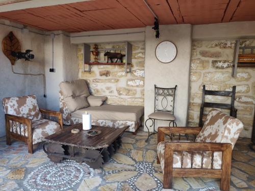 a living room with a couch and chairs and a table at Apartamentos Casa Nino in Montefrío