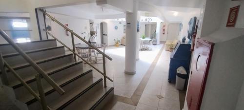 a view of a hallway with a staircase in a house at Hotel Casa Branca in Guarujá