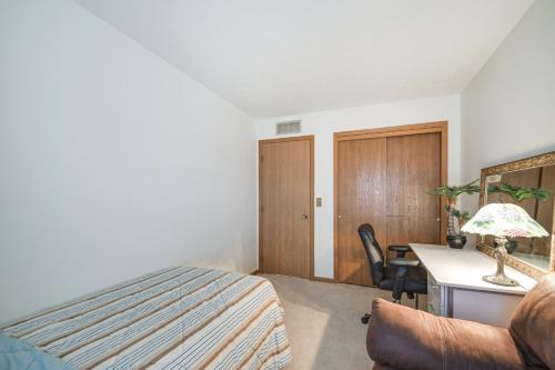 a bedroom with a bed and a desk with a chair at Welcoming Condo in Davenport Central Location! in Davenport