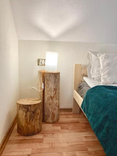 a bedroom with a bed and a table with a lamp at Fajne Domki in Władysławowo-Chłapowo