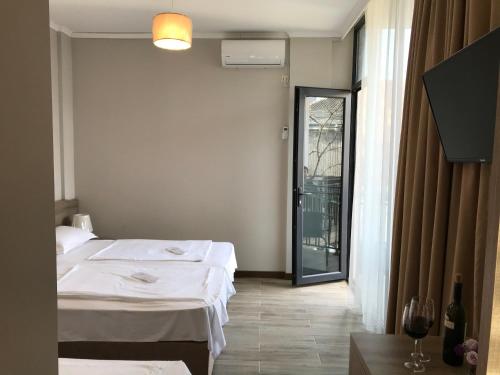 a hotel room with a bed and a window at Nina two in K'obulet'i