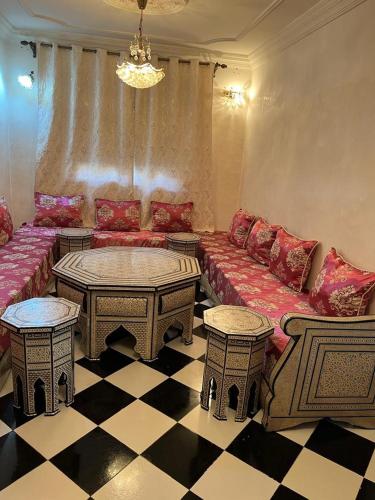 a living room with a couch and two tables at Azrou ifrane in Azrou