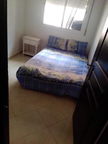 a small bed in a room with a window at Azrou ifrane in Azrou