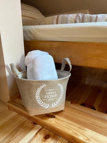 a basket of towels is sitting under a bunk bed at Vikendica Una in Kolašin