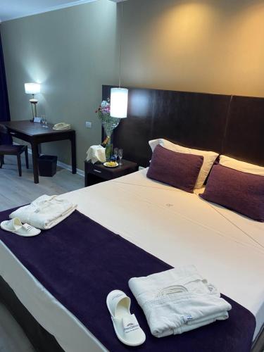 a hotel room with a bed with towels on it at Howard Johnson Plaza by Wyndham Buenos Aires Florida Street in Buenos Aires