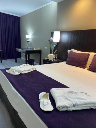 a hotel room with a bed with towels on it at Howard Johnson Plaza by Wyndham Buenos Aires Florida Street in Buenos Aires