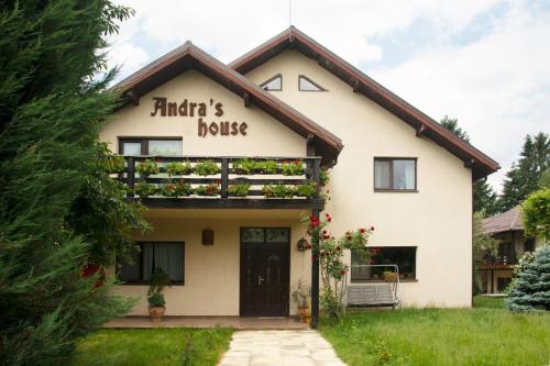 a white house with a sign that reads filberts book at Pension Andra's House in Horezu