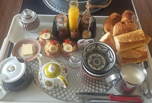 a tray of food with bread and eggs and toast at La Billardière Camping à la Ferme in Le Ménil-Ciboult