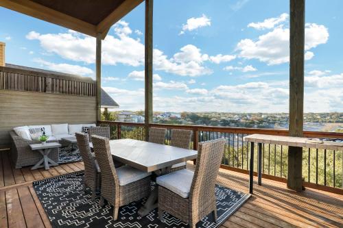 a patio with a table and chairs on a deck at Lake House - A Birdy Vacation Rental in Canyon Lake