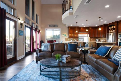 a living room with two couches and a table at Lake House - A Birdy Vacation Rental in Canyon Lake