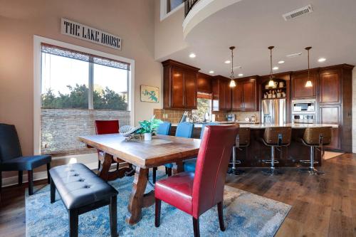 a kitchen and dining room with a wooden table and chairs at Lake House - A Birdy Vacation Rental in Canyon Lake