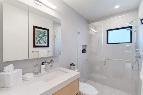 a white bathroom with a sink and a shower at Dazzling Modern Home Close to Downtown Palo Alto and Stanford in Menlo Park
