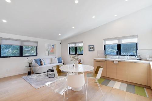 a kitchen and living room with a table and a couch at Dazzling Modern Home Close to Downtown Palo Alto and Stanford in Menlo Park