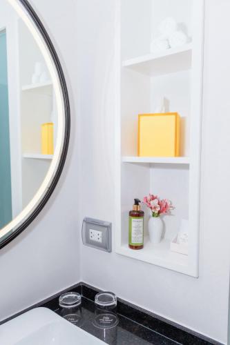a bathroom with a mirror and a sink at Manto Hotel Lima - MGallery Collection in Lima