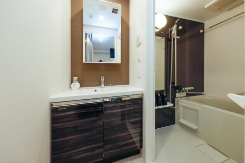 a bathroom with a sink and a bath tub at Seaside Tamachi - Vacation STAY 15583 in Tokyo