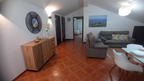 a living room with a couch and a table at O Miradouro in Angra do Heroísmo