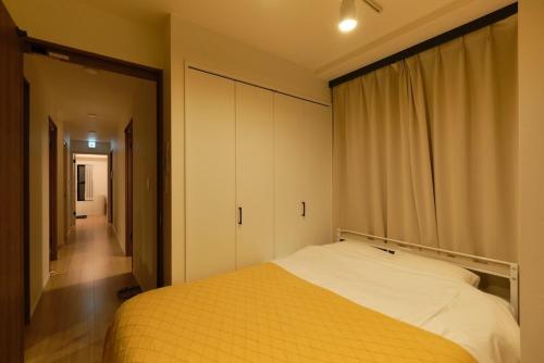 a bedroom with a yellow bed and a closet at Kiyosumi SOHO4B, 5th floor, 6th floor - Vacation STAY 20622v in Tokyo