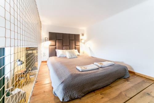 a bedroom with a bed with two towels on it at Warsaw Concierge Metro Loft in Warsaw