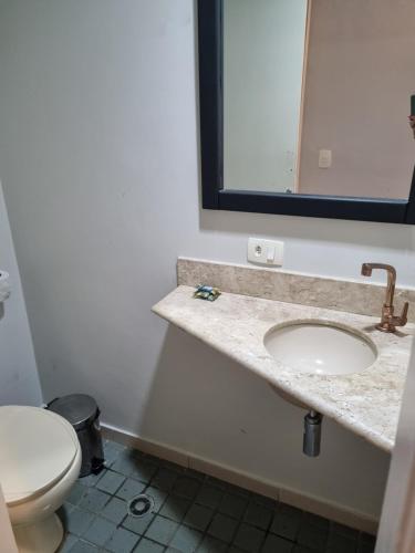 a bathroom with a sink and a toilet at Max Savassi Glamour in Belo Horizonte