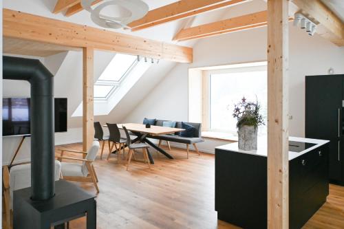 a kitchen and living room with a wood stove at Arton Lachtal - Apartments Steiermark in Lachtal