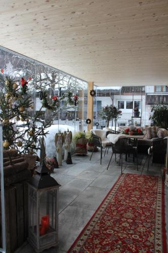 a living room with a christmas tree in the middle at Haus am Rain in Partenen